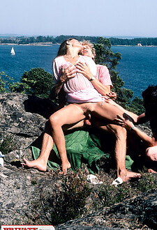 Lonely girl walking by the beach is surprised by two friends