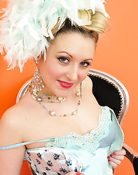 Saucy blonde showgirl in corset and white fishnet stockings knows how to tease. - Photo #1