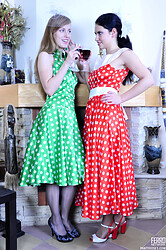Two lesbian babes make a vintage party dressing up in silky polka-dot frocks and sleek shiny pantyhose. - Photo #1