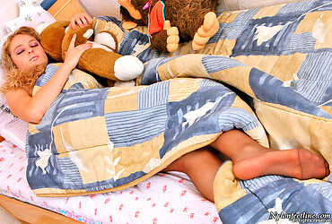 Naughty babe lazily lying in bed right in her suntan control top pantyhose - Photo #1