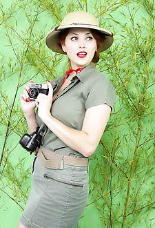 Busty redhead loses her clothes in jungle