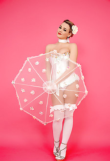 Glamorous brunette in corset and stockings shows off her gorgeous curves.