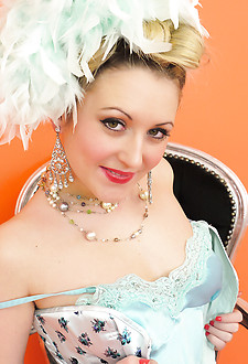 Saucy blonde showgirl in corset and white fishnet stockings knows how to tease.