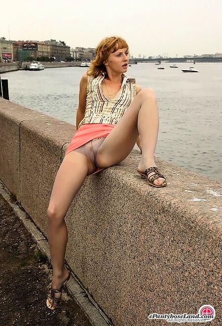 Sensuous outdoor upskirt tease performed by the teen in grey pantyhose