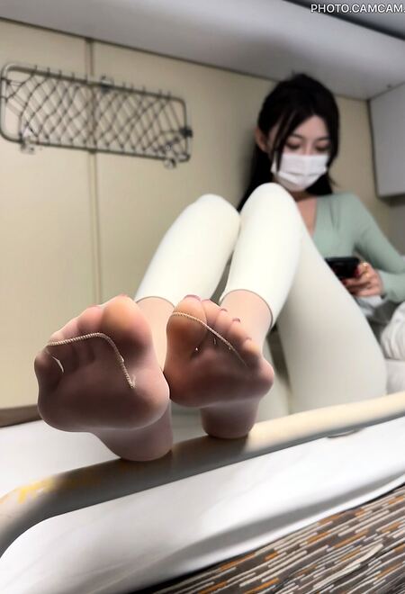 Asian chick shows her ass, legs and feet in ripped pantyhose